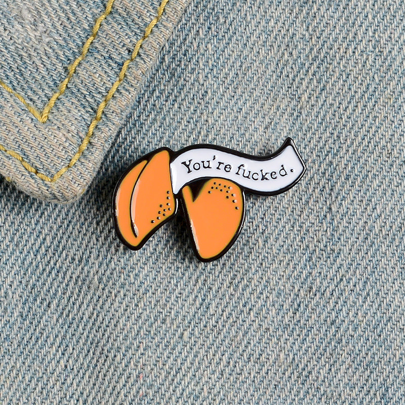 Enamel pin with cartoon fortune cookie dripping oil